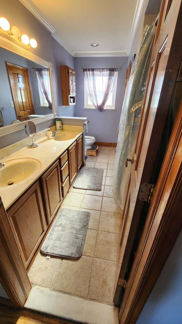 bathroom featuring vanity, toilet, and ornamental molding