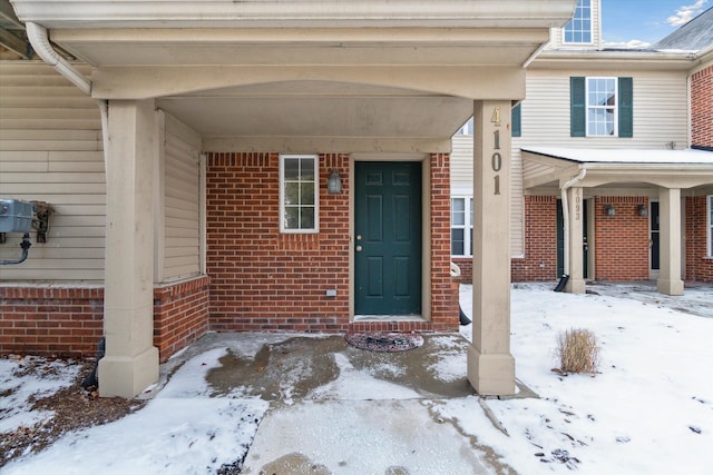 view of snow covered property entrance