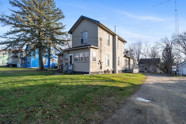 view of side of home with a lawn