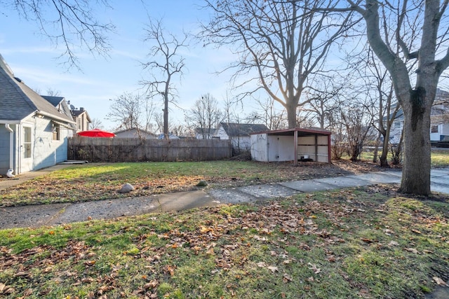 view of yard featuring an outdoor structure and fence