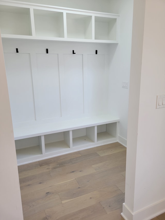 mudroom featuring baseboards and light wood-type flooring