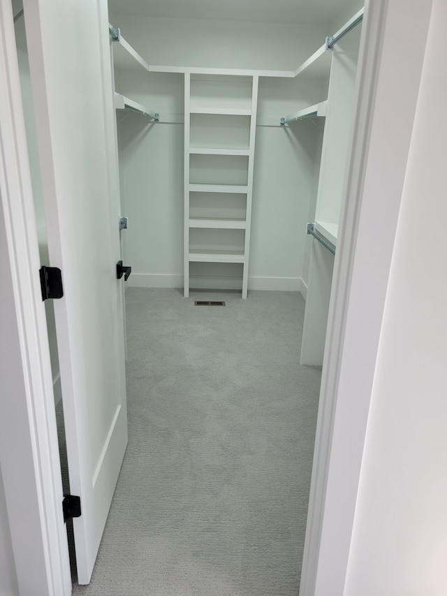 spacious closet featuring visible vents and carpet