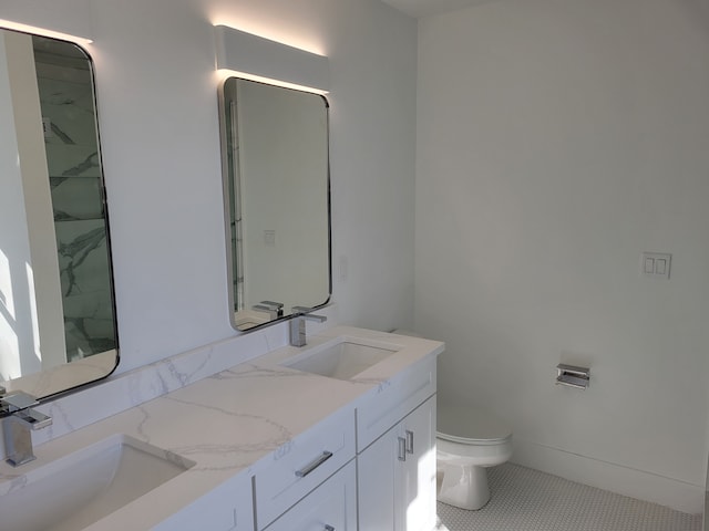 full bathroom featuring a sink, toilet, and double vanity