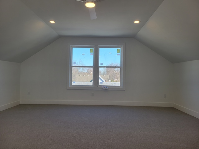 additional living space with recessed lighting, dark carpet, baseboards, and vaulted ceiling