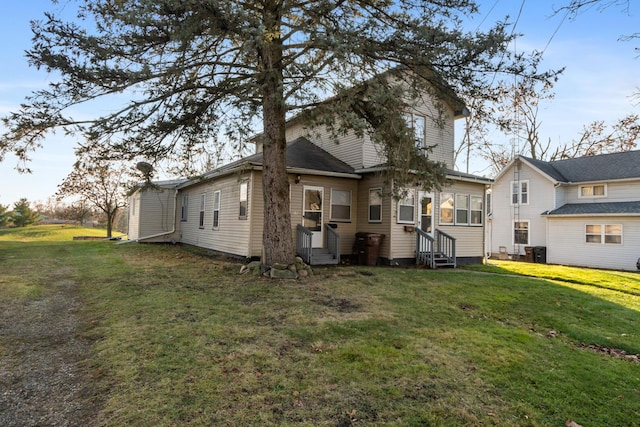 back of house with a lawn