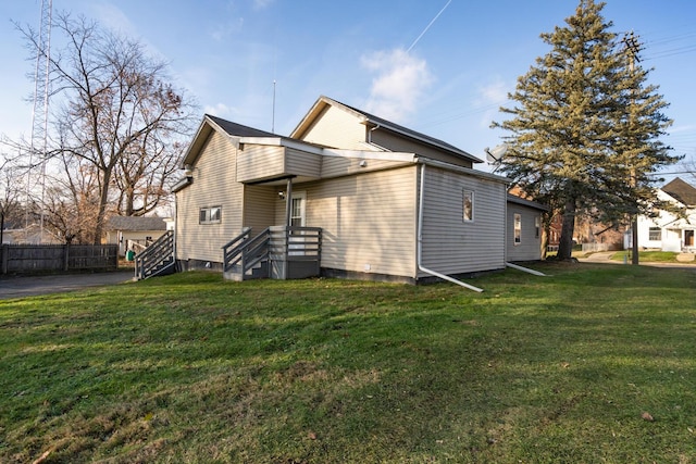 rear view of property featuring a yard