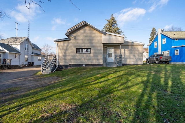 back of house with a lawn