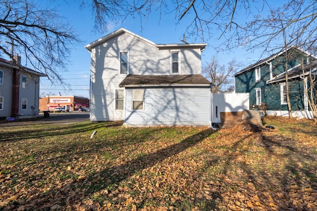 back of property featuring a yard