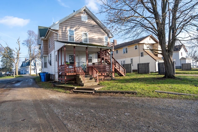 view of front of home featuring covered porch and a front lawn