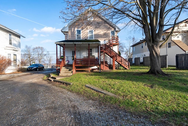 view of front facade with a front lawn and covered porch