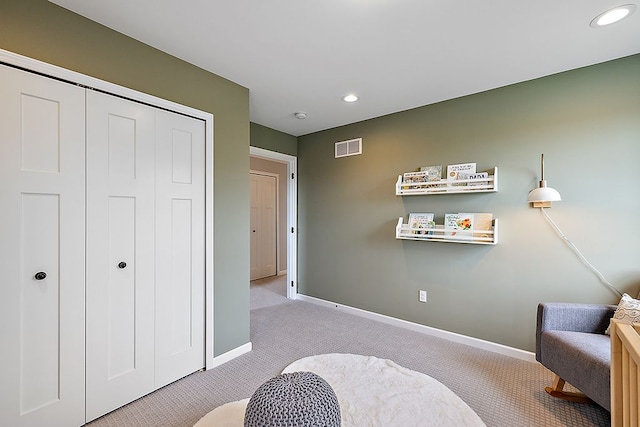 living area featuring light carpet