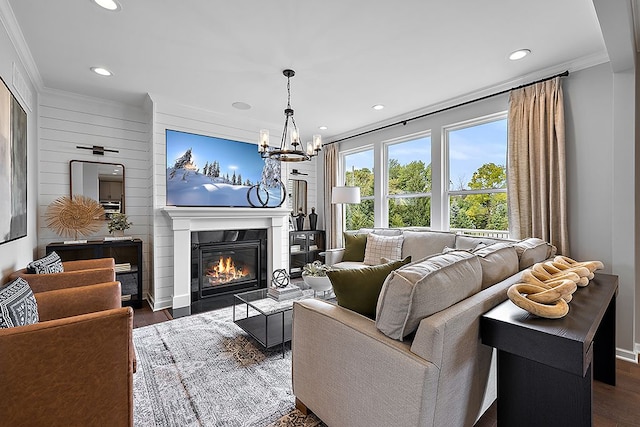 living room with a chandelier, crown molding, and dark wood-type flooring