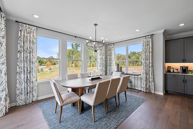 dining space with a chandelier, dark wood-type flooring, and ornamental molding