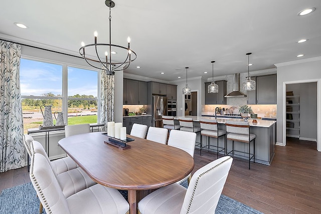 dining room with crown molding, dark hardwood / wood-style floors, and an inviting chandelier