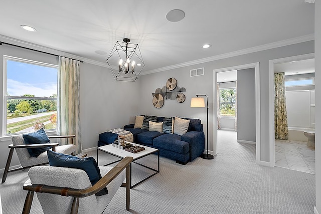 living room with an inviting chandelier, crown molding, a healthy amount of sunlight, and light colored carpet