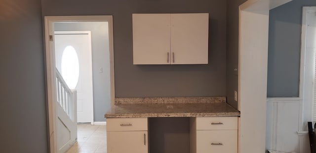 kitchen with light tile patterned floors and built in desk