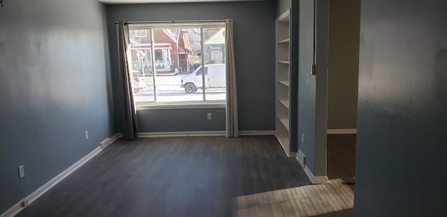 spare room with dark hardwood / wood-style flooring