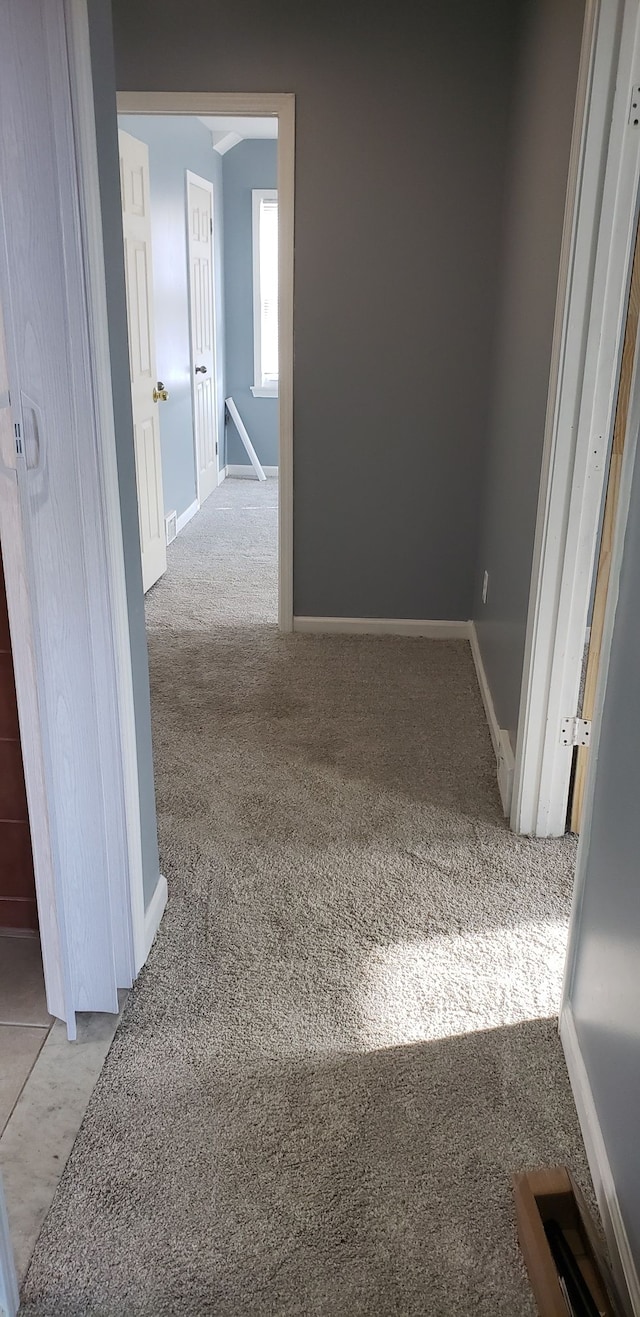 hallway with light colored carpet