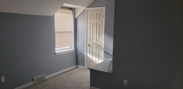 empty room with carpet and lofted ceiling