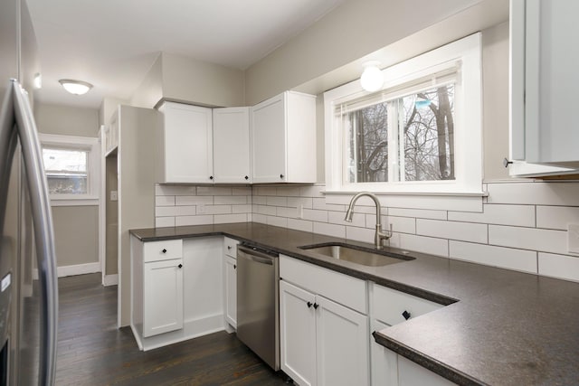 kitchen featuring dark hardwood / wood-style floors, white cabinetry, sink, and appliances with stainless steel finishes