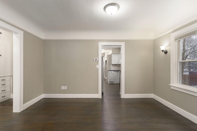 unfurnished room featuring crown molding and dark wood-type flooring