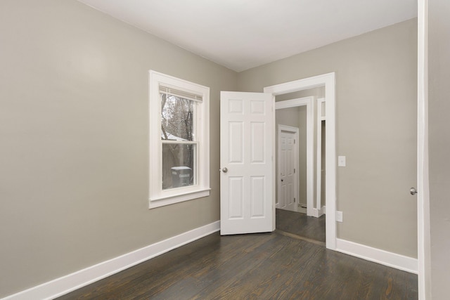 unfurnished bedroom featuring dark wood-type flooring