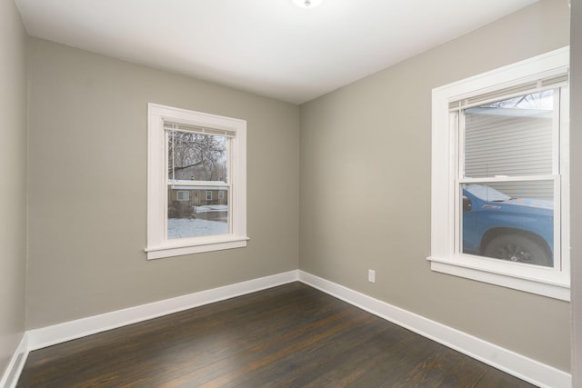 empty room featuring dark hardwood / wood-style floors and a healthy amount of sunlight