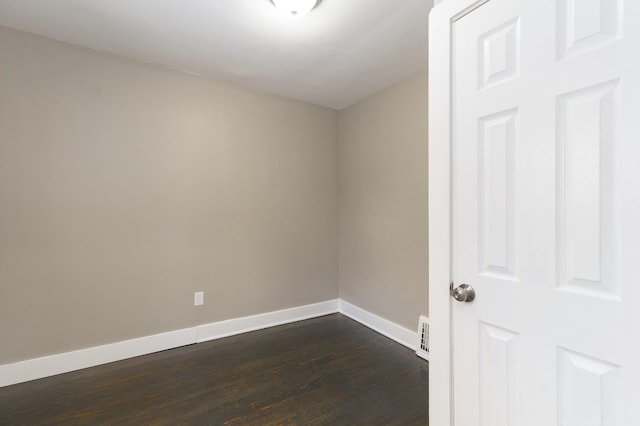 unfurnished room featuring dark wood-type flooring