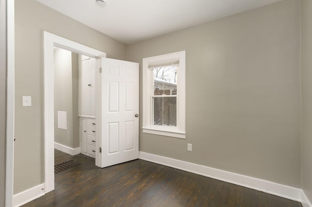 unfurnished bedroom with dark hardwood / wood-style floors