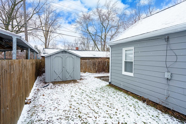 yard covered in snow with a storage shed