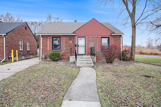 bungalow-style house with a front yard