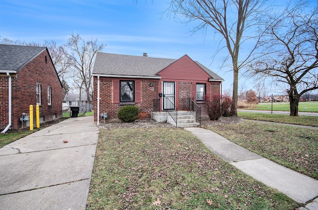 bungalow-style house featuring a front yard