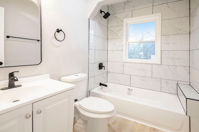 full bathroom featuring hardwood / wood-style flooring, vanity, toilet, and tiled shower / bath combo