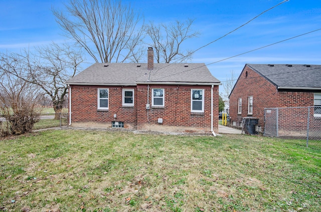 rear view of house with a yard