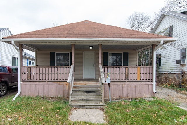 bungalow with cooling unit and covered porch