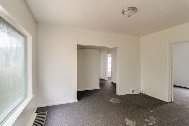 carpeted spare room with a wealth of natural light