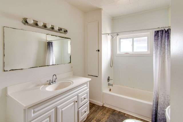 bathroom with hardwood / wood-style floors, vanity, and shower / bathtub combination with curtain