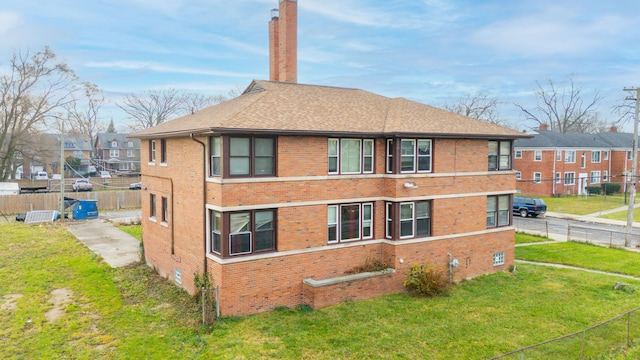 view of side of home featuring a lawn