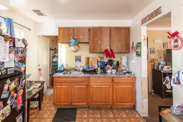 kitchen featuring refrigerator