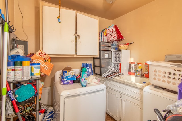 laundry area featuring cabinets, washer / dryer, and sink