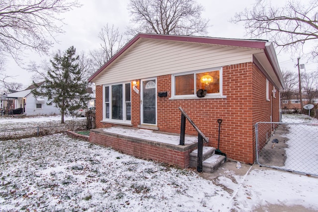 view of snow covered rear of property