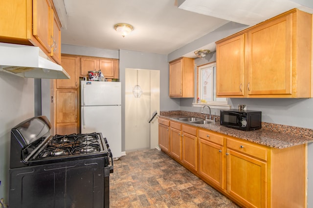 kitchen with sink, dark stone countertops, and black appliances