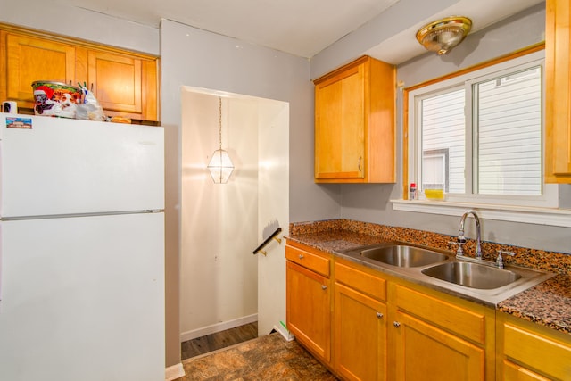 kitchen featuring white refrigerator, dark hardwood / wood-style flooring, and sink