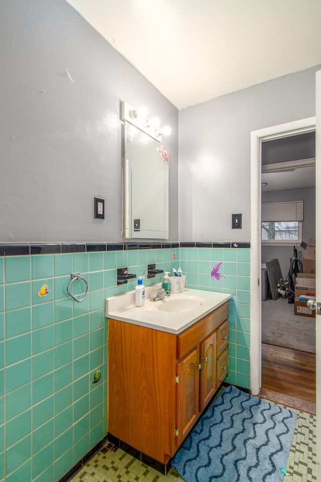 bathroom featuring hardwood / wood-style floors, vanity, and tile walls