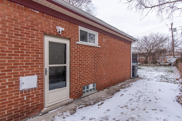 view of snow covered property entrance