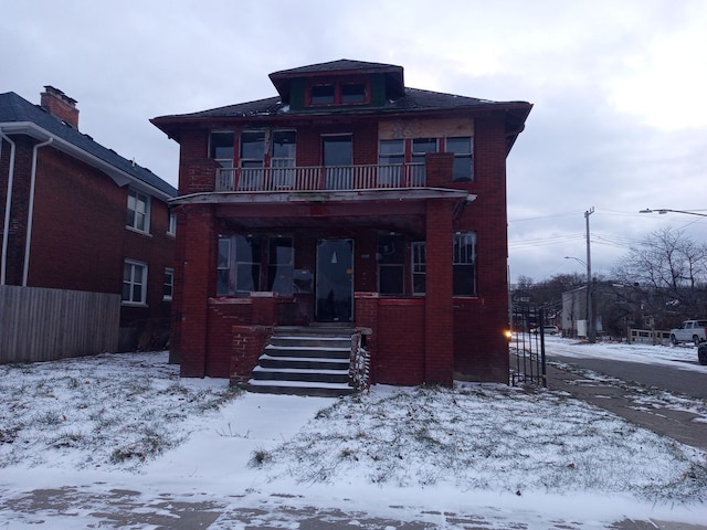 view of front facade with covered porch and a balcony