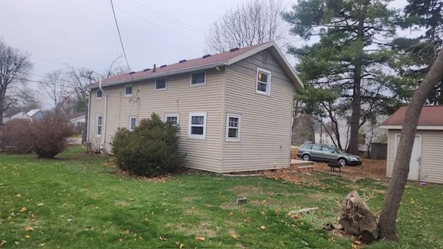 view of side of home featuring a lawn