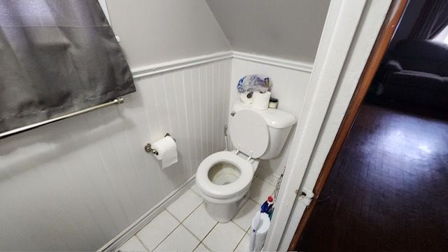 bathroom with toilet and wood-type flooring