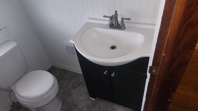 bathroom featuring vanity and toilet