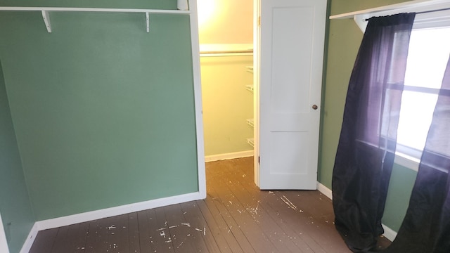 interior space with dark hardwood / wood-style floors and a closet